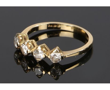 18 carat gold diamond set ring, with a row of four diamonds to the head, ring size M 1/2