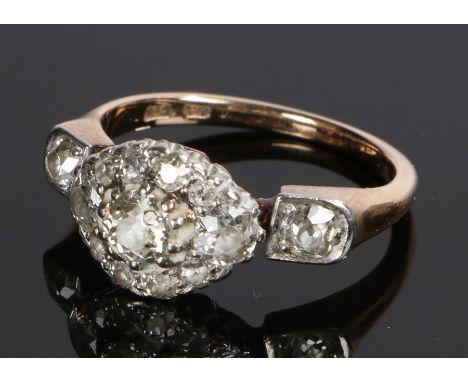 18 carat gold diamond cluster ring, the head with a central round diamond with an oval multiple diamond surround with a furth