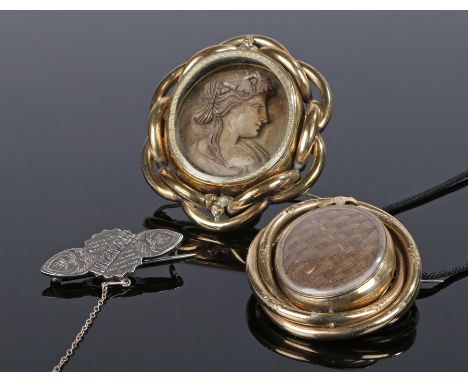 Jewellery, to include a cameo brooch behind a glazed front and a scroll frame, 7cm high, the second brooch with woven hair an