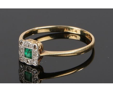 18 carat gold emerald and diamond set ring, the central emerald with a diamond surround, ring size P