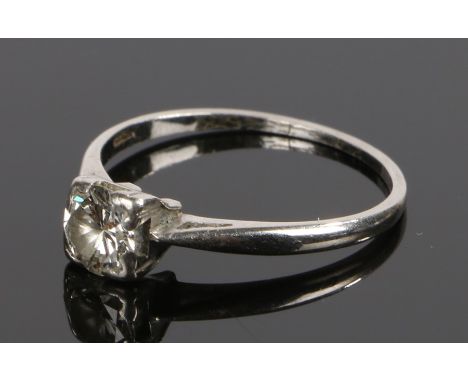 Platinum and diamond set solitaire ring, the round diamond at approximately 0.50 carat held within corner claws, ring size O