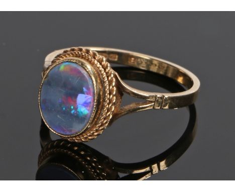 9 carat gold and opal ring, the head above divided shoulders and with rope weaved effect under the oval opal, ring size Q 1/2