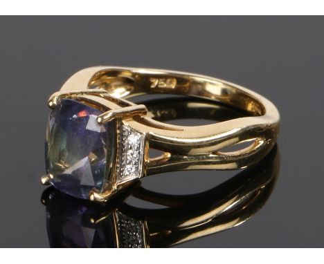 18 carat gold gem set ring, the central emerald cut gemstone with blue top and bottom and central green band, three diamonds 