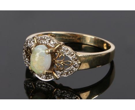 9 carat gold, opal and diamond ring, the opal set to the centre with a diamond arched surround, ring size P 1/2