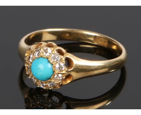 18 carat gold turquoise and diamond set ring, the central turquoise with a diamond surround, ring size M