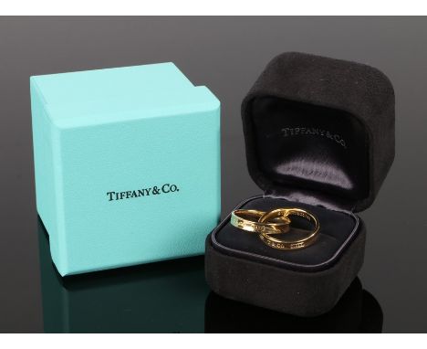 Tiffany, pair of linked 18 carat gold rings, 8.1 grams, ring size N, boxed 