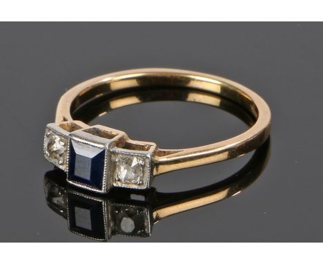 18 carat gold sapphire and diamond set ring, the central square cut sapphire flanked by a diamond to either shoulder, ring si