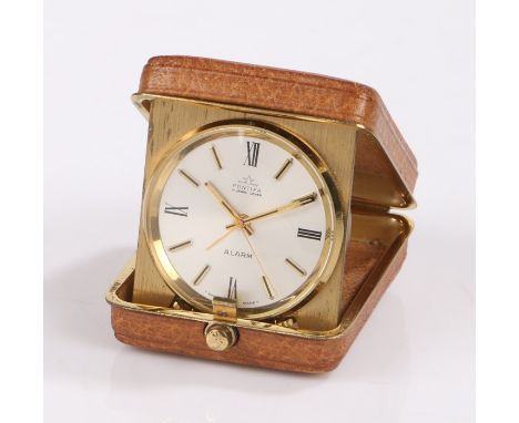 Pontifa travelling alarm clock, the brown leather exterior opening to reveal a gilt mounted alarm clock, the silvered dial wi