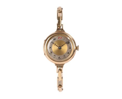 9 carat gold ladies wristwatch, the dial with central gold roundel and silvered chapter ring with Arabic numerals, crown woun