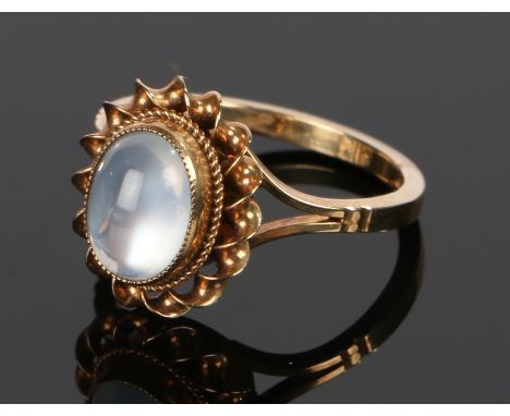 9 carat gold ring,  with cabochon moonstone set to the rope twist mount and pierced shoulder, ring size M