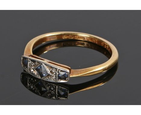 18 carat gold diamond and sapphire set ring, with three sapphires and four diamonds to the head, ring size 