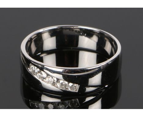 18 carat white gold diamond set ring, with five round cut diamonds to the shank, ring size Q