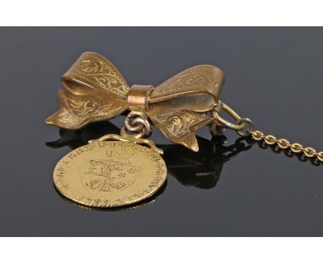 George II half Guinea suspended from a bow brooch  