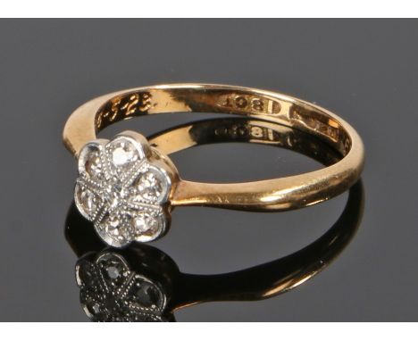 18 carat gold diamond set ring, with seven diamonds to the flower head, ring size K 1/2