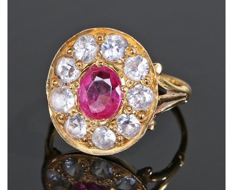 Ruby and white sapphire set ring, the yellow metal ring with a central ruby and white sapphire surround, ring size L