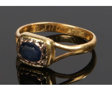 19th Century yellow metal ring, set with a worn blue stone within a mount having a monogram to the reverse of the head, the i