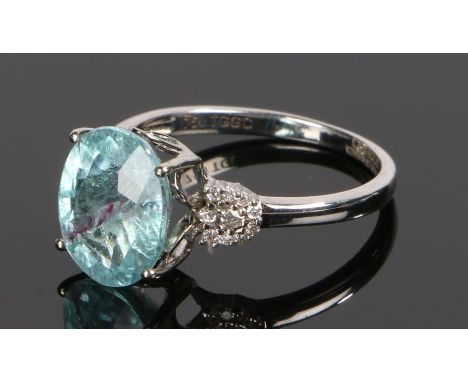 18 carat white gold Paraiba tourmaline ring, the Paraiba tourmaline with a purple line to the midway to the gemstone, flanked