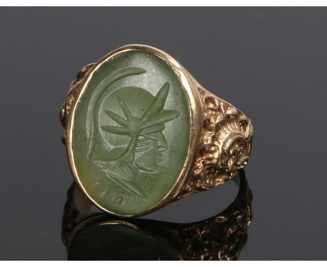 9 carat gold signet ring, the seal head with the profile of a helmeted figure, ring size V