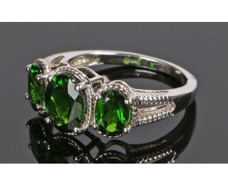 9 carat white gold ring, set with three oval green stones to the head, ring size O