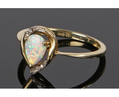 10 carat gold and opal set ring, the pear cut opal with round cut diamonds to the top and bottom, ring size N 1/2