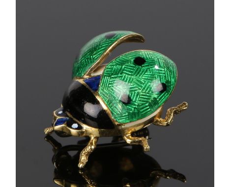 18 carat gold and enamel lady bird brooch, with green open wings and black head, 22mm long, 7.5 grams