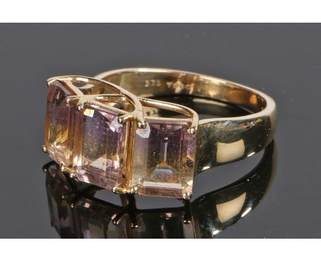 9 carat gold ring, set with three emerald cut gemstones with pink, purple and orange toned bands to each, ring size O