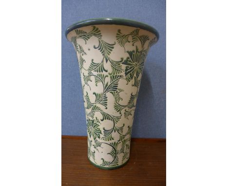 A large cream and green ceramic vase 