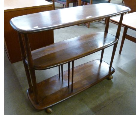 An Ercol Golden Dawn elm and beech Giraffe trolley/bookcase 