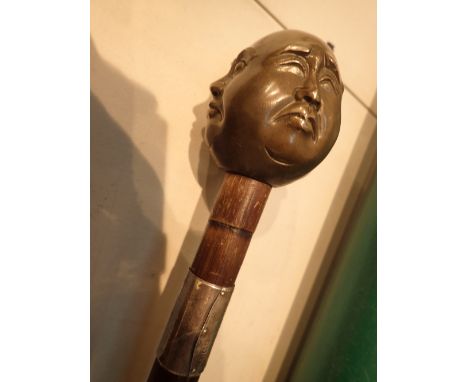 Brass four faced Buddha walking stick with silvered collar