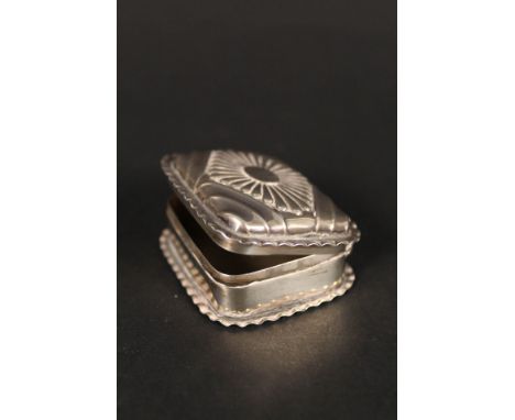 A silver snuff box with frilled edge and embossed lid, hallmarked Birmingham 1892