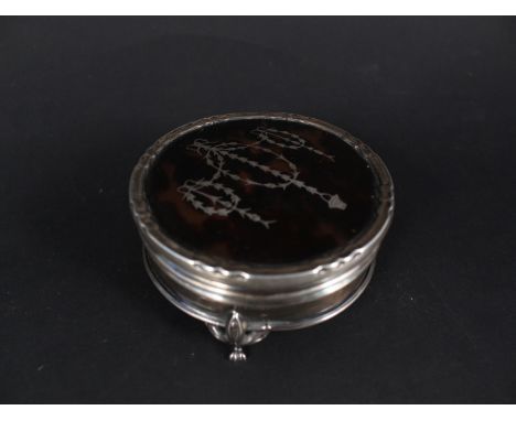 A circular silver and tortoiseshell ring box with inlaid decoration to lid (marks are rubbed)