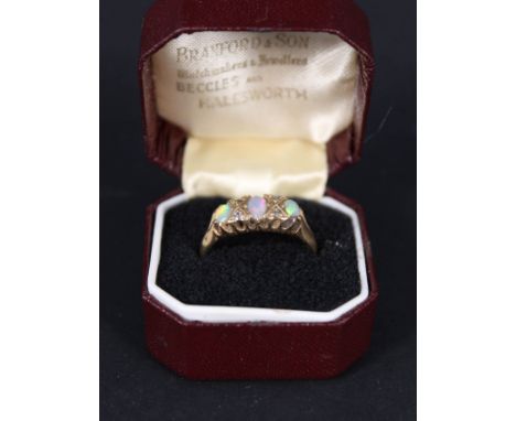 An 18ct gold opal and diamond set ring, size S (one opal chipped)