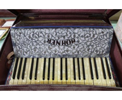 A Hohner piano accordion plus various sheet music