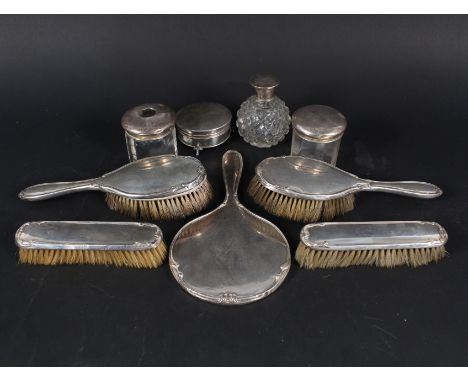 Silver dressing table items including mirror, brushes, jars and a silver ring box