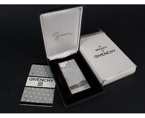 A silver plated Givenchy lighter in box