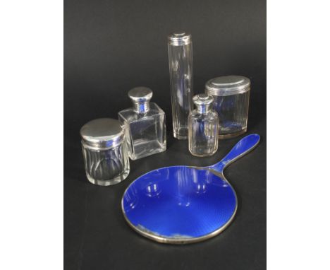 A silver blue enamel dressing table mirror (as found) and a quantity of silver topped glass jars (most monogrammed)