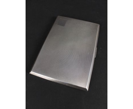 A large silver cigarette case with engine turned decoration, vacant cartouche