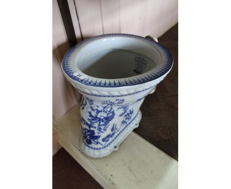 A Pryke &amp; Palmer 'motor' brand blue and white toilet pan with floral decoration