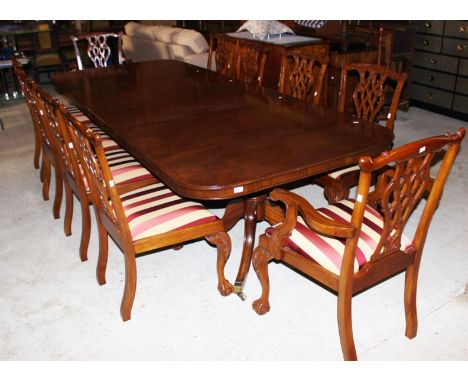 A modern mahogany twin pedestal dining table, two extra removable leaves, together with a set of ten Chippendale style dining