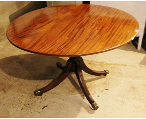 A George III mahogany tripod table, having a circular top, tripod base