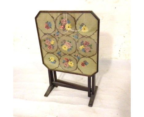 A 1930s oak octagonal glazed tapestry firescreen with fold down top and gateleg (77cm upright. d. 51cm)