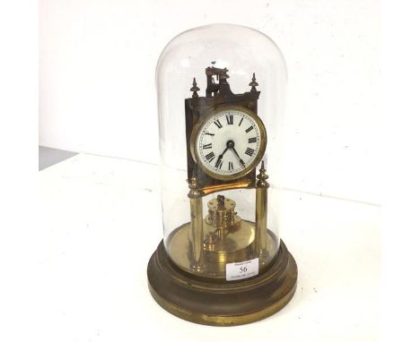 A late 19thc gilt metal skeleton clock, the enamel dial with roman numerals, stamped GB verso, on circular metal base, under 