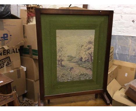 A 1930s walnut framed snap top firescreen/occasional table with sewn work panel, raised on shaped end supports (82cm x 63cm)