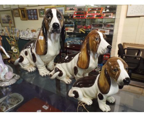 A Graduated Set of Three Ceramic Basset Hounds 