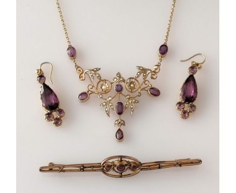 An Edwardian integrated gold chain pendant with amethyst and seed pearl decoration, stamped 9ct; similar brooch, 8.5 cm, unma