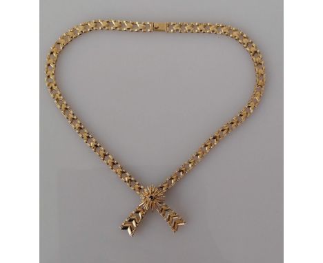 A 9ct yellow gold fancy-link necklace with integrated bow pendant and ruby decoration, hallmarked, 38 cm, 21g