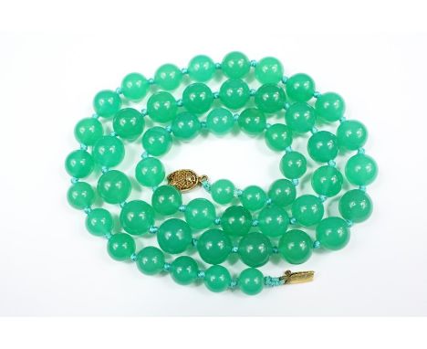 A Chinese Green Agate Necklace, suspended from a silver clasp, approx 62 cms, approx beads measure approx 7mm to 11mm togethe
