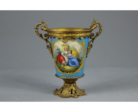 An Antique Sevres Gilt Ormolu Twin-Handled Vase. The vase with gold foils in shallow relief enclosing a floral spray on one s