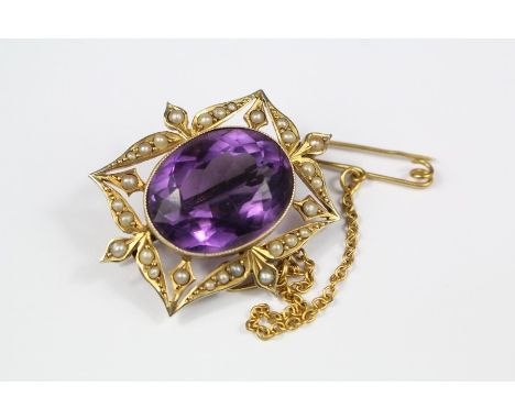 An Edwardian 9ct Amethyst and Seed Pearl Brooch. The amethyst measures approx 18 x 15 mm, on a 9ct gold safety chain, approx 
