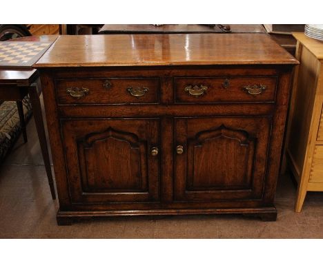 Antique Oak Sideboard; the sideboard having two short drawers, double cupboards beneath with one shelf, approx 115 x 87 x 52 